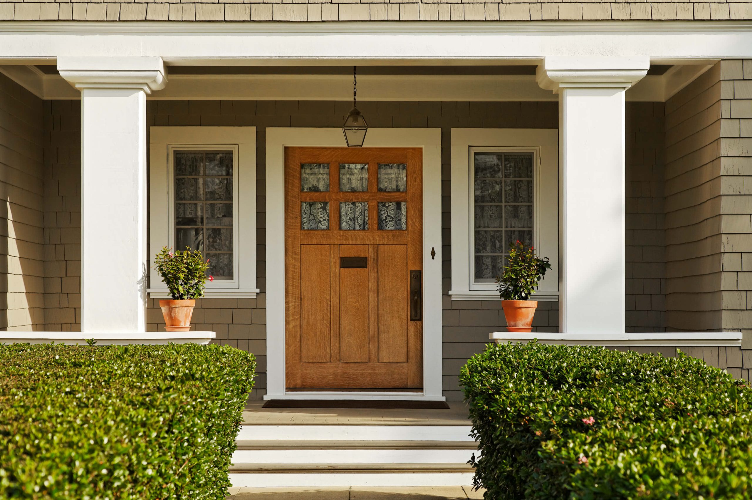 Front porch with brown front door